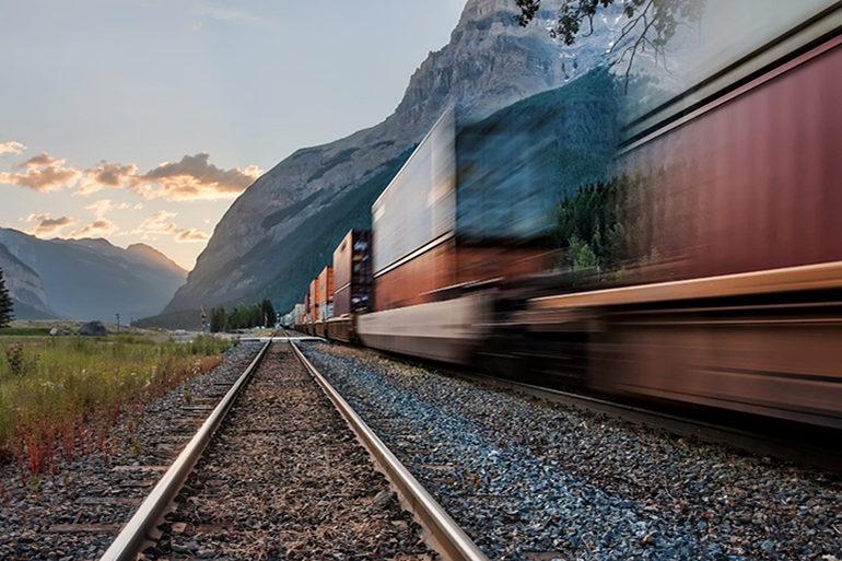 Speeding cargo train, mountains on background