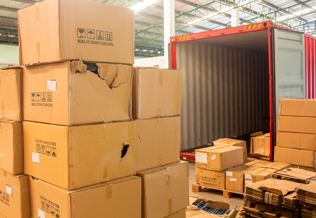Damaged carton boxes taken out of the shipping container