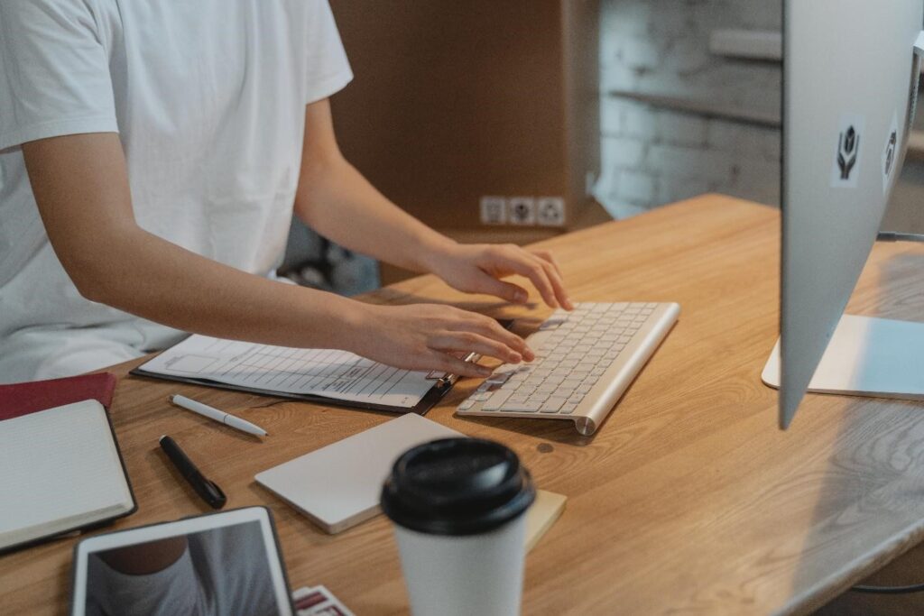 Human behind the computer drafting an commercial invoice