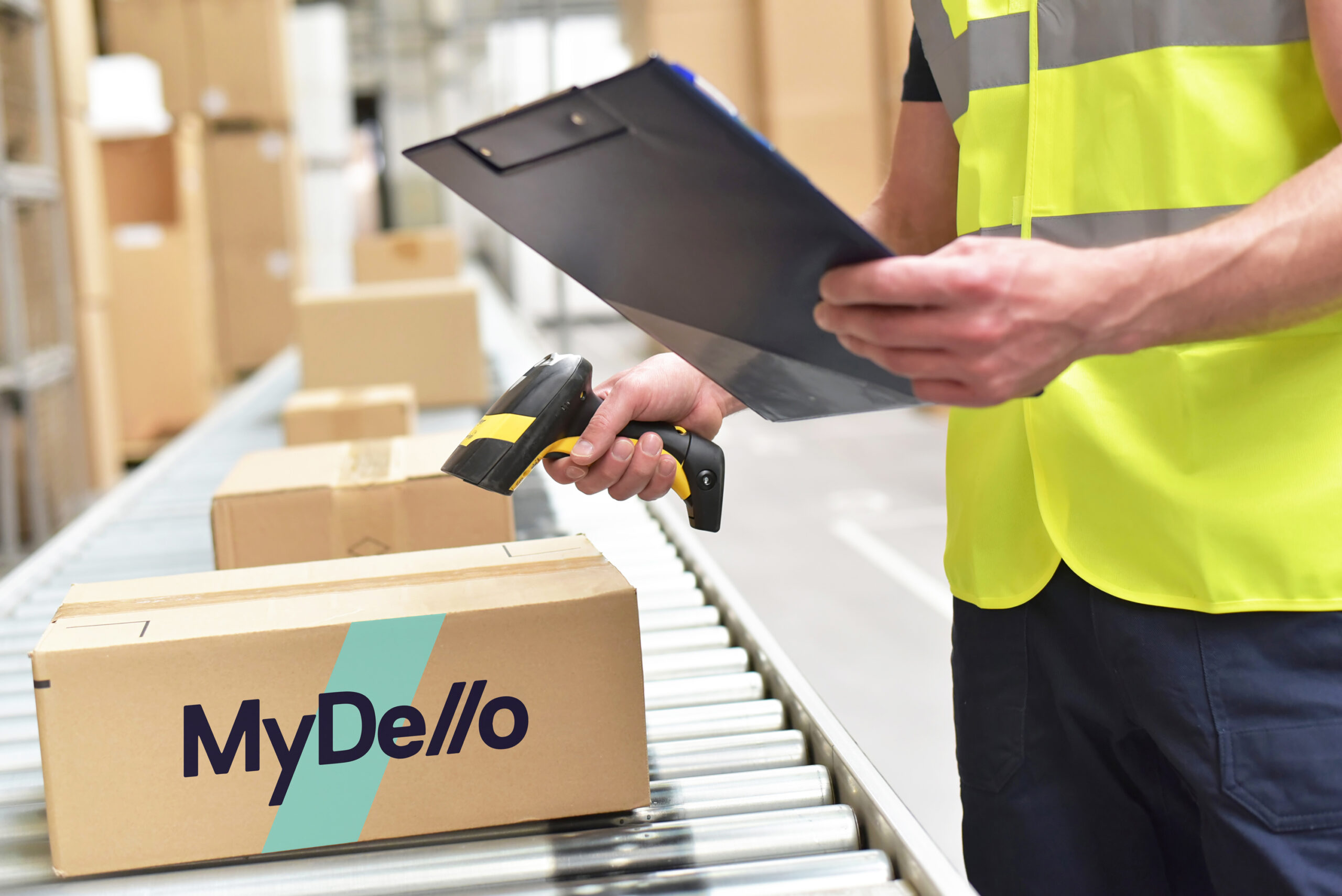 Warehouse worker holding documents and scanning the package