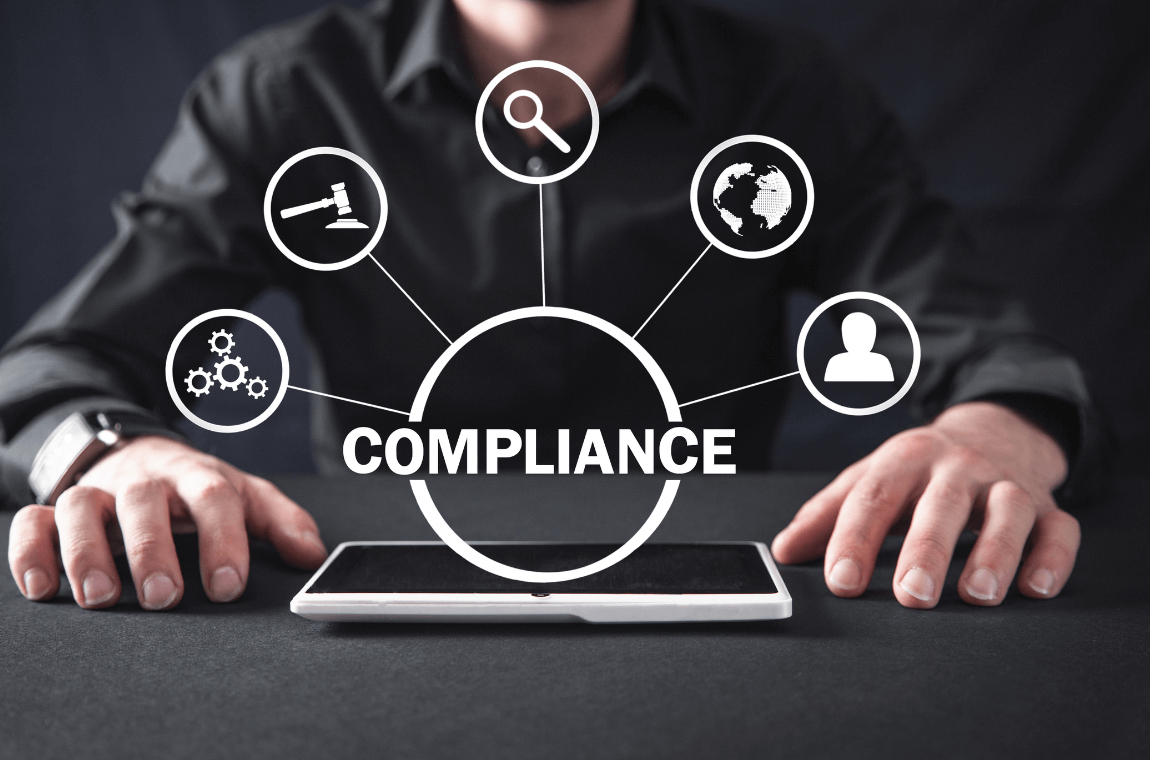 Logistics manager navigating compliance on a computer with 'Compliance' overlay illustration.