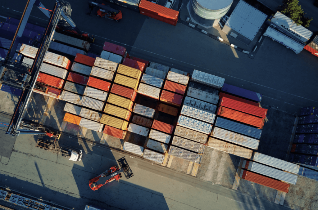 Loading of shipping containers at a port, illustrating MyDello's transformative impact on Freight Forwarding.