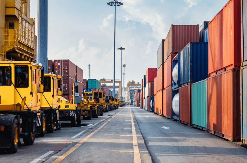 Fully loaded dock with containers and loaders, representing the reality of capacity constraints in logistics.
